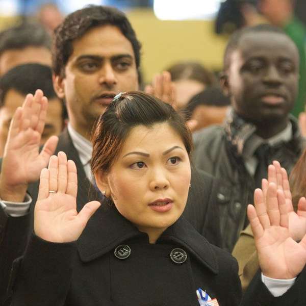 A woman raising her hand in front of a crowd